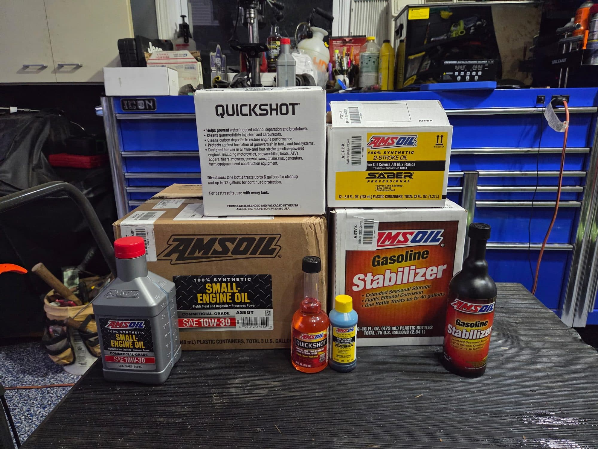 AMSOIL small engine oil, Quickshot, gasoline stabilizer and two-stroke oil on the bench