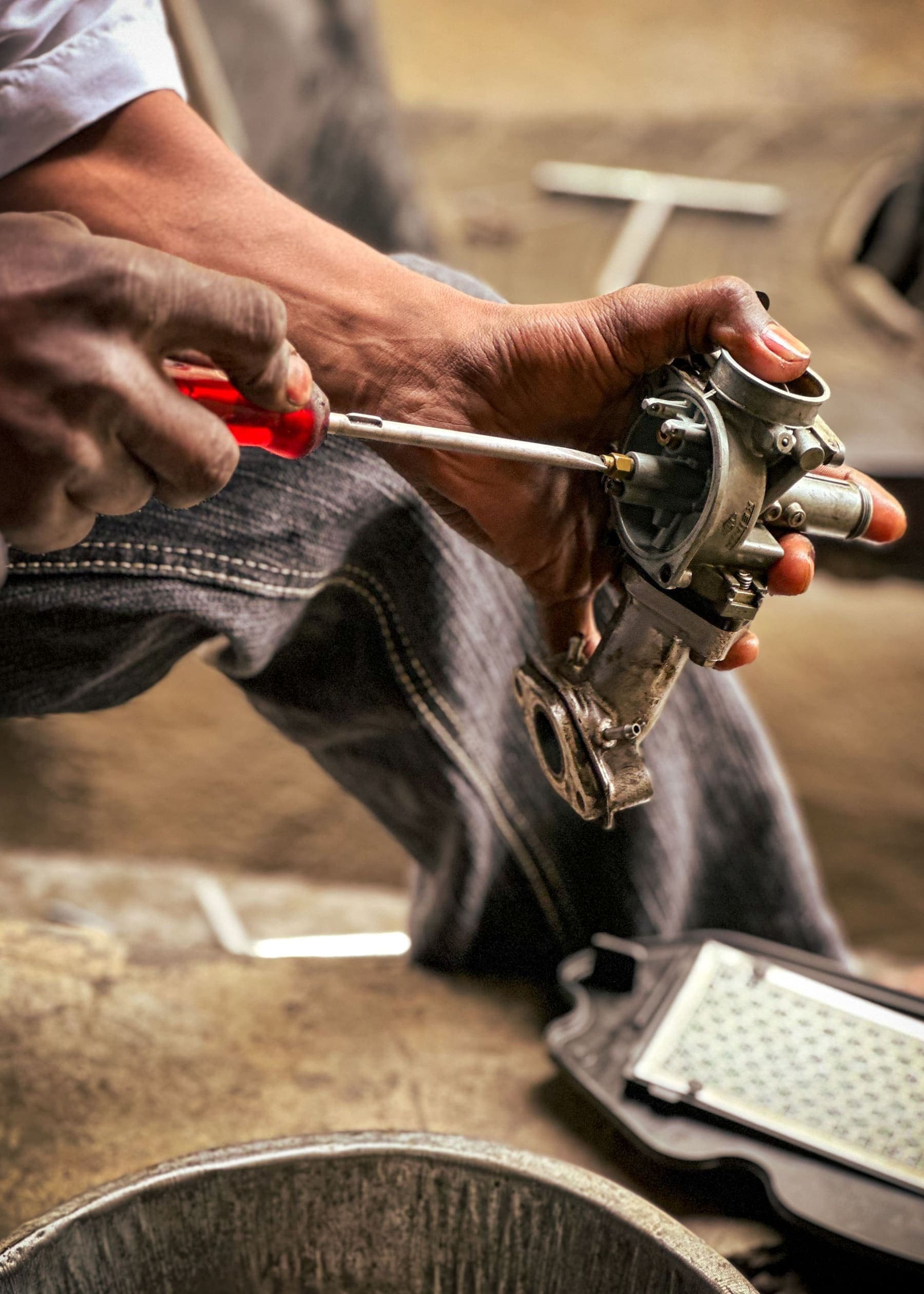 Screwdriver on a small carburetor